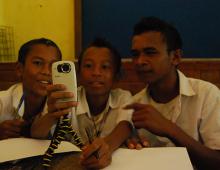 Three school boys from Timor Leste are looking at the camera.